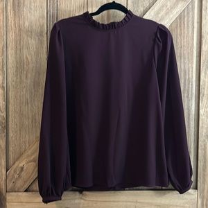 Beautiful plum, purple blouse with ruffle neckline